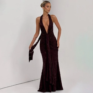 Detailed view of deep V-neck halter gown with textured fabric and waist draping