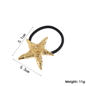 Detail view of golden starfish hair tie showing size 5.3cm by 5.1cm and 11g weight