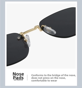 Detail view of ergonomic golden metal nose pads and grey lenses on oval sunglasses