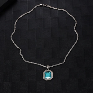 Detail of silver twist chain with square blue sapphire pendant and micro-inlaid diamonds
