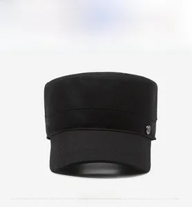 Front view of black flat top cadet hat with twill fabric and side metal logo detail