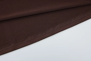 Detailed close-up showing the double-stitched hem and dark brown knit fabric texture