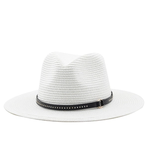 Close-up of a white straw fedora hat featuring a black leather band with metallic studs