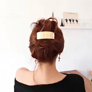 Minimalist gold rectangular metal hair clip shown on model for back hairstyle