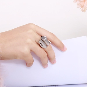 Close-up of minimalist silver stainless steel geometric wide band ring on female finger