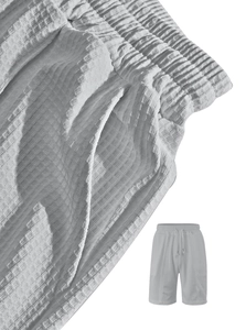 Close-up of light grey waffle texture fabric and drawstring waist on men's casual shorts