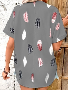 Detail view of the colorful feather prints and cuffed sleeves on this gray summer shirt