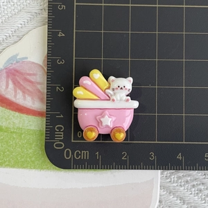 Close-up of resin cartoon white cat in pink star car for DIY craft accessories