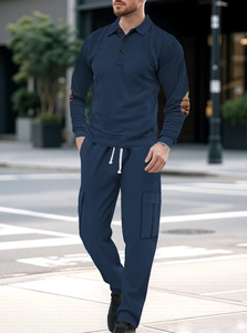 Detail of navy blue ribbed knit men's polo set with three-button collar and cargo pocket