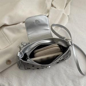 Chic silver polka dot crossbody bag with PU leather, showing interior storage capacity