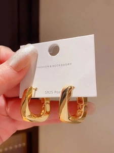 Dettaglio di orecchini a cerchio quadrati irregolari placcati oro con perno in argento S925