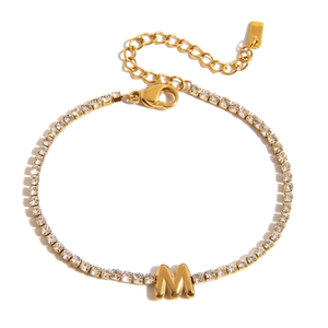 Detail of 18K gold tennis bracelet featuring cubic zirconia M initial and adjustable chain