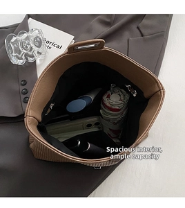 Top view of spacious interior of brown tote bag holding umbrella and phone
