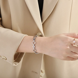 Minimalist silver stainless steel chain bracelet and ring set worn by model