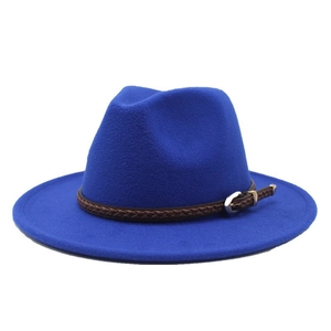 Close-up of royal blue wool fedora hat with brown braided leather band and silver buckle