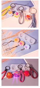 Detail of DIY cat paw resin molds with LED light-up keychains and tassels