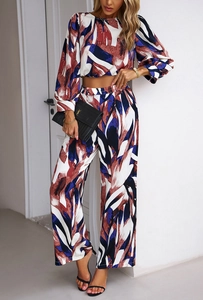 Close-up of women's two-piece set with abstract blue and red print and wide-leg pants