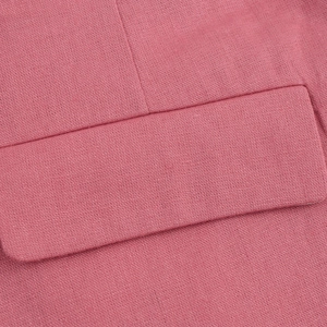 Detailed macro view of pink woven fabric texture and stitching on the pocket flap