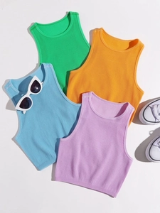 Flat lay of colorful ribbed knit crop tops with sunglasses and sneakers for summer look