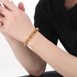 Detailed view of punk skeleton bone link bracelet in vacuum-plated gold on wrist