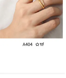 Detail of 18k gold layered ring with twisted design and white crystal inlay for women