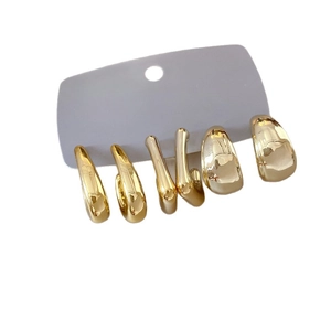 Three pairs of golden C-shaped hoop earrings in various widths with high polished finish