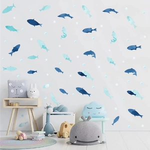 Watercolour ocean fish wall decals for children's room in blue shades on a white wall