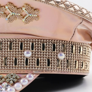 Close-up of pink metallic leather military hat with pearls, rhinestones and golden studs