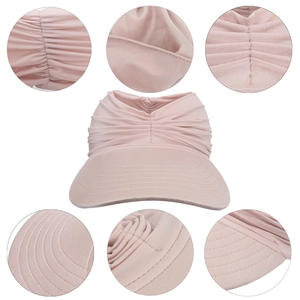 Detail view of pink sun hat showing fine stitching on brim and elastic fabric texture