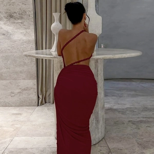 Detail of burgundy backless dress showing woven one-shoulder strap and pleated fabric