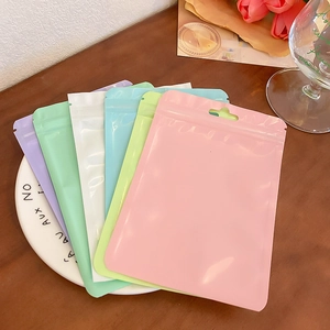 Colorful resealable zip lock storage bags for jewelry and brushes on a decorative plate
