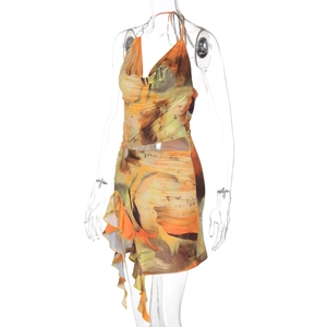 Detail view of abstract print halter dress with side cut-out and asymmetric ruffled hemline