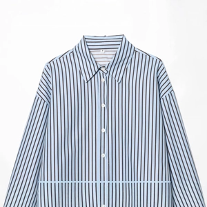Flat lay of a classic light blue striped poplin shirt with a button-down collar