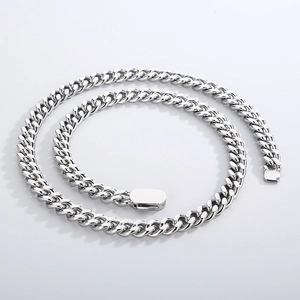 Detailed macro view of silver stainless steel Cuban link chain with a secure buckle clasp