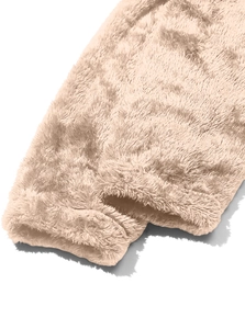 Close-up of soft apricot polar fleece jacket fabric showing plush texture and cuff detail
