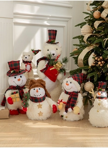 Detail of Christmas snowman and polar bear plush dolls with red plaid fabric accents
