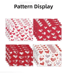 Close-up of stitched edges and fabric texture on red heart pattern dining placemats