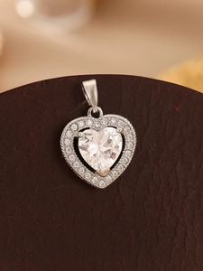 Macro shot of silver heart pendant with brilliant faceted cubic zirconia stones