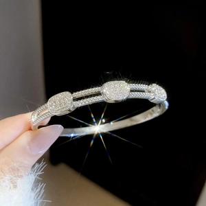 Macro shot of silver-tone zircon hollow cuff bracelet with sparkling starburst accents