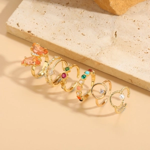 Detail of 6pcs gold ring set with butterfly, pearls and colorful resin stones