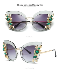 Detail of cat eye sunglasses with grey frame and leaf-shaped diamond crystal accents