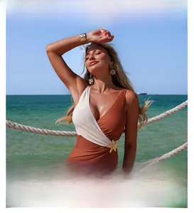 Detail of color-block swimsuit with deep V-neck and golden starfish waist ornament
