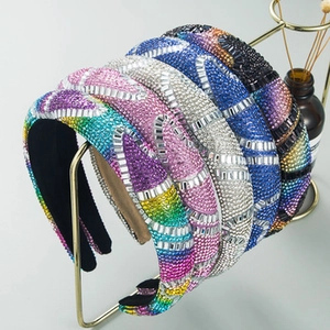 Detailed view of colorful baroque padded headbands with sparkling rhinestone embellishments