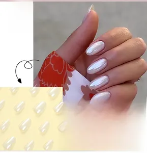 Detail view of pearlescent white oval press-on nails with a minimalist French style finish