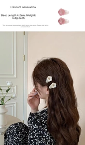 Detail showing the 4.2cm floral hair clip size and model side view on warm background