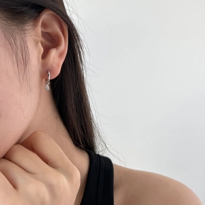 Close-up of S925 silver earring with a round clasp and water drop zircon pendant