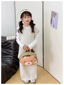 Toddler girl holding a cute khaki cartoon bear shaped lightweight preschool backpack