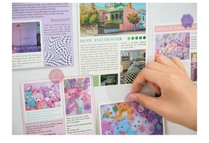 Detail showing hand applying translucent purple wax seal sticker to decorative postcard wall