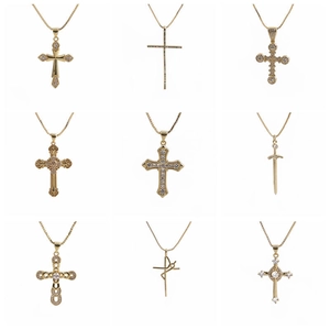 Collection of nine gold zircon cross and sword pendant necklaces on white background