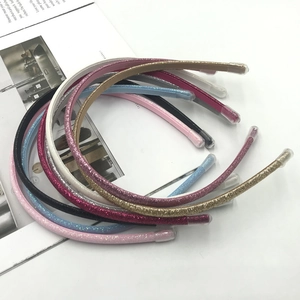 Set of slim glitter headbands in assorted colors like pink and gold with protective tips